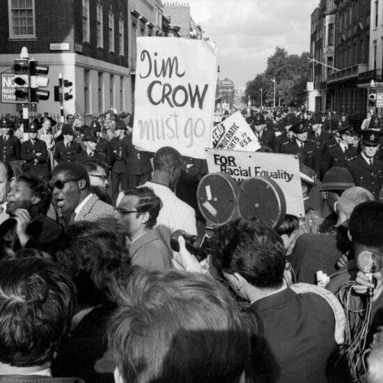 American boxer Cassius Clay speaks to the crowd whilst taking part in a Black Equality civil rights demonstration supportive of African Americans, during a stop at the corner of Park Street, W1 on the way to the American Embassy in London, circa 1963