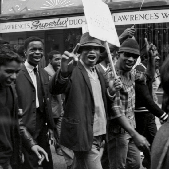 Marchers carry a banner whilst taking part in a Black Equality civil rights demonstration supportive of African Americans, London, circa 1963