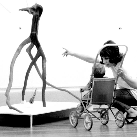 A woman points out a sculpture to a baby in a pushchair during the Alexander Calder retrospective show at the Tate Gallery, London, from 04 July to 12 August, 1962