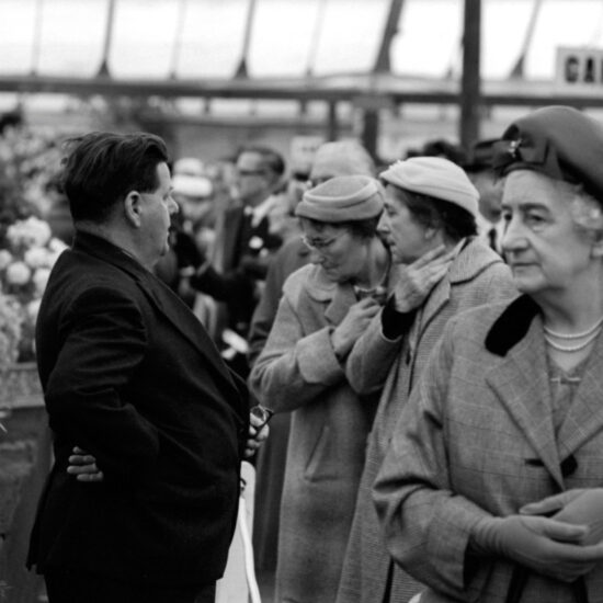 Middle-aged women in hats inspect the flower displays near gantry 3 at the  Chelsea Flower Show, London, 1962