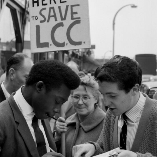 A young man signs the petition to save the L.C.C (London County Council) prior to it being replaced by the GLC (Greater London Council), London circa 1962
