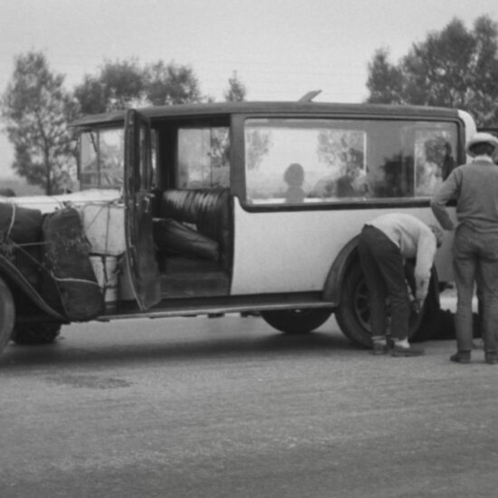 During the Cheltenham to Moscow trip the yellow hearse gets a roadside wheel change in a rural setting, USSR circa 1960